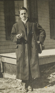 Unidentified young man standing by porch, 122