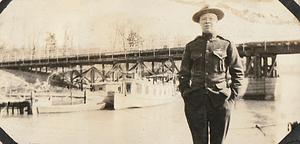 U.S. Marine in front of pier and boats, probably at U.S. Marine base Quantico, VA