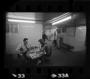 Two people play chess, North Slope camp, Anchorage, Alaska