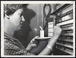 Candlelight was a necessity for voters in several Boston polling places today. Hurricane Donna cut the power. Above, Mrs. Nancy Riley, of West Roxbury, votes at Robert G. Shaw School in West Roxbury. Voting machines had to be operated manually.