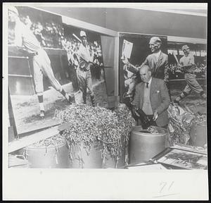 Moving Day for the A’s-Team effects of Philadelphia Athletics being packed by Roy Mack for shipment to Kansas City, new home of American League baseball club. Murals in background, reading from left, show Lefty Grove, Jimmy Foxx, Connie Mack and Home Run Baker.