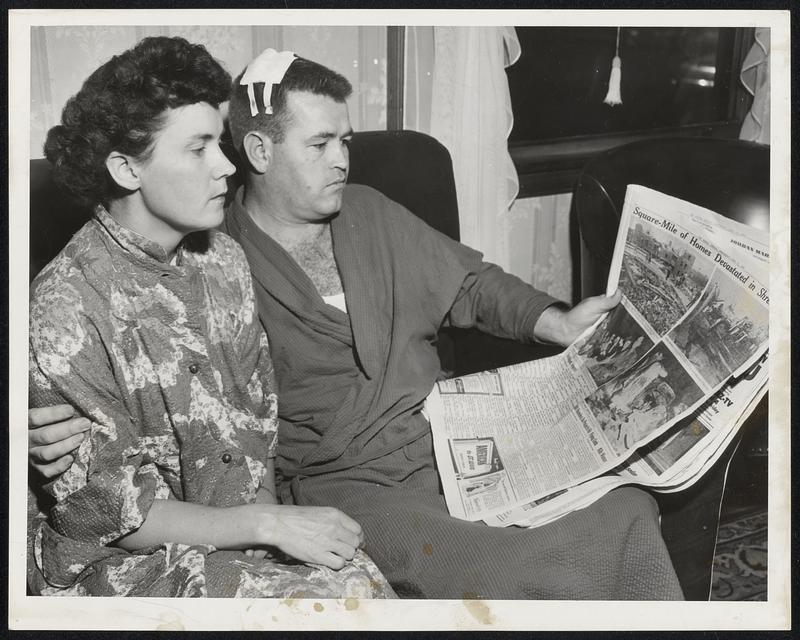 Rescued Their Children-Mr. and Mrs. Edwin Breslin of Shrewsbury who rescued their family of four children during the height of the tornado. They are looking at the Boston Hehald's photos of the ruins. Upper right hard picture in paper is of the home behind theirs.