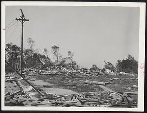 This Was A House - Splintered lumber is all that remains of a house in the Great Brook area of Worcester, where the tornado roared through full force. A battered telephone pole is all that remains standing.