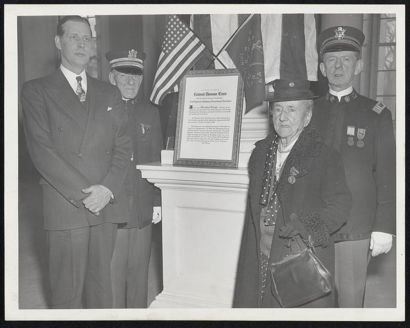 Temporary Memorial—to the old Ninth Regiment of Infantry, Massachusetts Volunteer Militia was unveiled yesterday in Doric Hall at the State House by members of the regiment’s association. Left to right- Gov. Tobin, William Leete, adjutant, of Brookline; Miss Evelyn F. Coughlin of Charlestown, daughter of Sgt. Jeremiah Coughlin, MVM, who was the guest of honor, and Capt. John Sheehan of Dorchester.