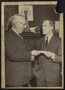 State-Federal Grant - Postmaster Ephraim Martin accepts $77,000 check from Secretary of State Kevin H. White for postage costs of state's mailing of 2,700,000 "Information to Voters" pamphlets. By law, every registered voter must receive one. They describe in detail six referendum questions that will be on the ballot on Nov. 3.