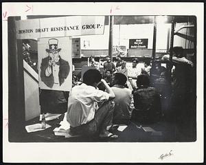 Draft - age young men gather at night-time session to learn about deferment.
