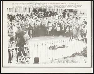 Dublin, Ireland: A group of demonstrators watches as an effigy of Pres. Richard Nixon burns outside U.S. Embassy here 10/4, during protest against U.S. policy in Vietnam. At one point a group of 15 extremist Maoist students briefly battled with police as they tried to get into the forecourt of the Embassy.