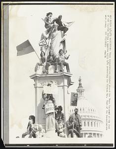 These demonstrators climbed aboard the Peace Monument at the foot of the Capitol during a massive rally 4/24 protesting the Vietnam War. Most of the demonstrators were young.