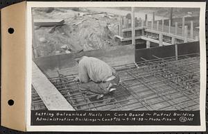 Contract No. 56, Administration Buildings, Main Dam, Belchertown, setting galvanized nails in cork board, patrol building, Belchertown, Mass., Apr. 14, 1938