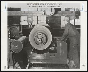 5000-Pound Capacity coil lifter by Lewis-Shepard Products Inc. of Watertown can raise a giant coil to nine inch heights through the action of a foot pedal. The machine runs on rails.