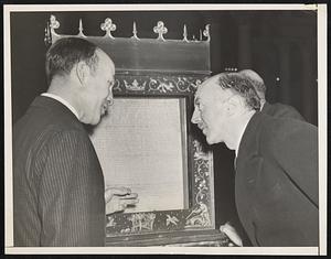 Magna Carta Deposited in Congressional Library. Photo shows Mr. Neville Butler, Charge de Affairs of the British Embassy, (right), and Archibald MacLeish, Librarian of the Library of Congress, examining the Lincoln Cathedral Copy of the Magna Carta after it was placed in a case in the Library of Congress here today. The famous document was signed in 1216 and is insured for 100,000 pounds and will be on display for the duration of the war.