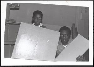 Boy and man holding up cardboard