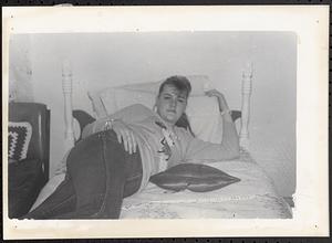 Young woman lying on a bed