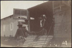 Soldier (Rough Rider) leading horse from railcar