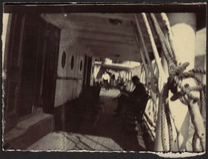 Deck of ship, people in background