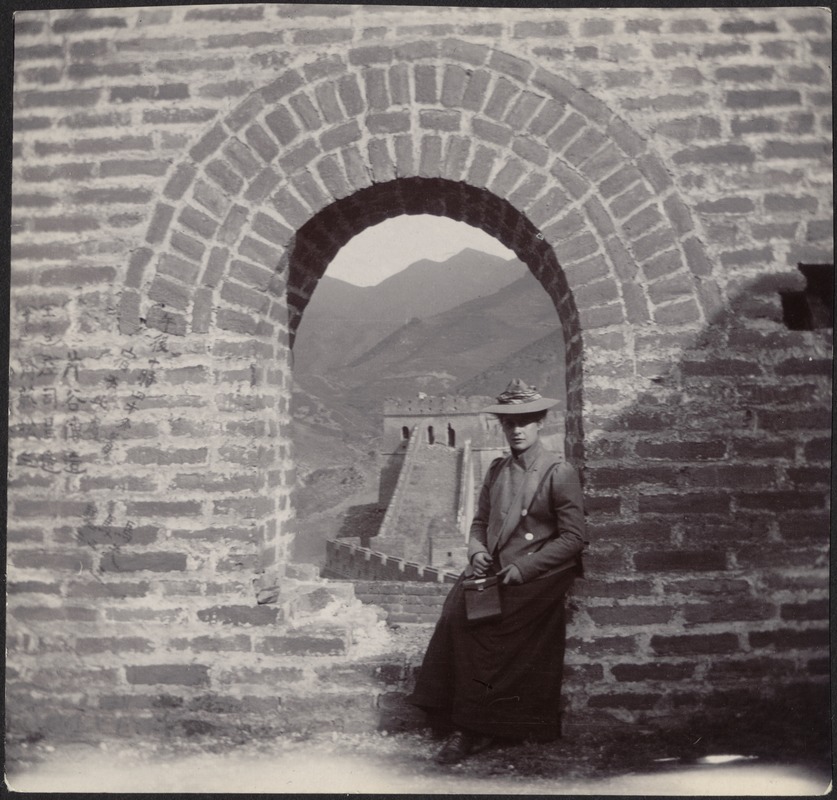 Woman in hat seated in ancient stone arched window, with views of the Great Wall (possibly Laura Conger Buchan or her cousin, Mary Pierce Hammond)
