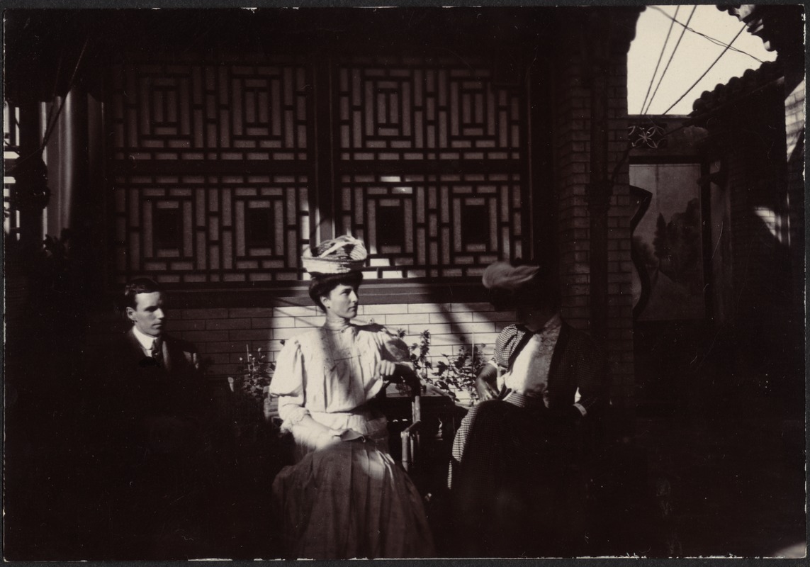 Man and two women (unidentified) visiting JGC's house in Peking, China