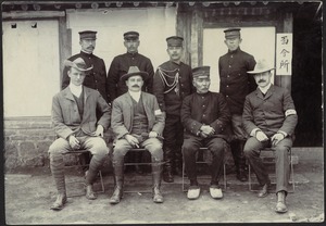 Military officials and members of western Legations (8) posing outside of building