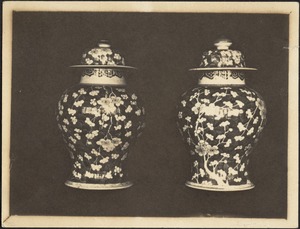 Two porcelain Chinese jars with lids; cherry or apple blossom motif