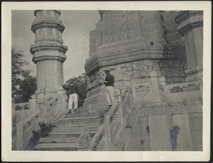 Two unidentified men in military uniforms on top step of White pagoda at Yellow Temple