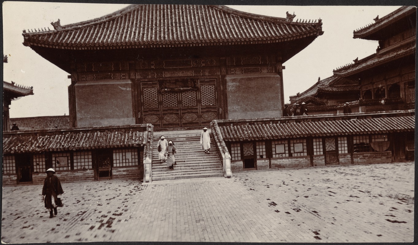People walking down steps of building in the Forbidden City