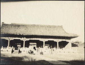 Horses in front of building, possibly stables at the Forbidden City