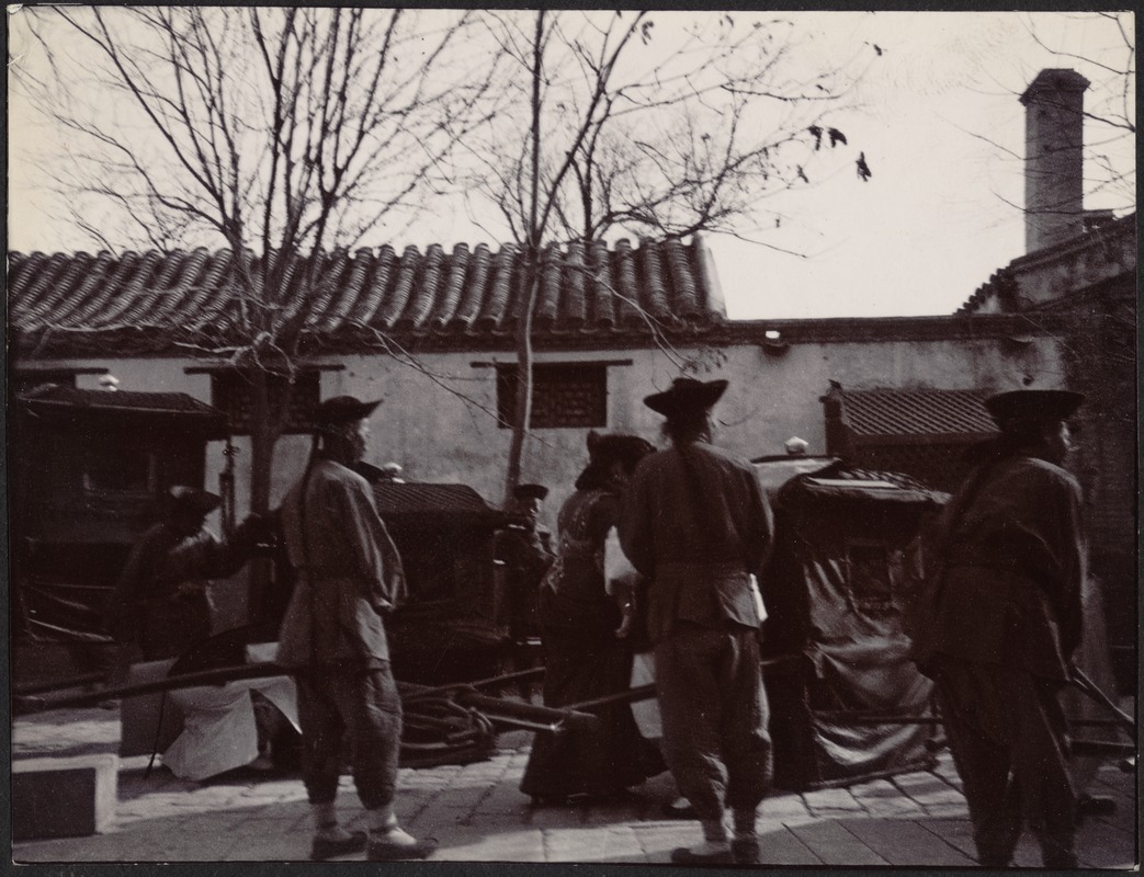 Chinese woman appearing to board a carriage or rickshaw; five men in attendance