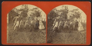 Group of six women and two men playing croquet