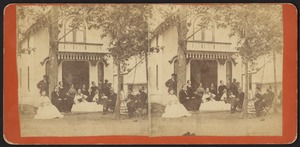 Group photograph of eight women and six men outside of a cottage on Martha's Vineyard