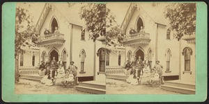 People posing on the porch and balcony of a cottage in Martha's Vineyard