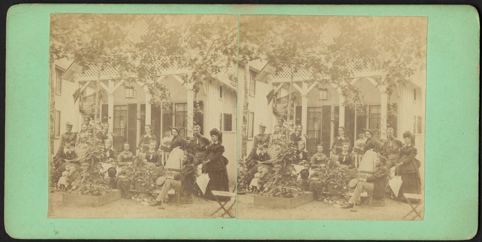 Group photograph of eighteen people outside a small cottage on Martha's Vineyard