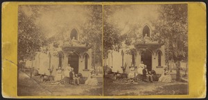 Five women and one man by the front steps and one woman on the balcony of a cottage in Martha's Vineyard