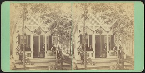 Five men seated in chairs on the porch of a cottage