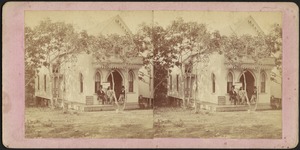 Portrait of three men and a boy in front of cottage, with a sign advertising real estate brokers selling cottages and lots