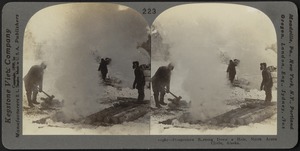 Prospectors burning down a hole, north of the Arctic Circle, Alaska