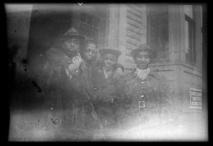 Four people stand posing