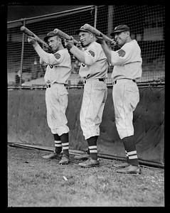 Three Boston Braves players holding bats like rifles