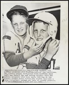 New Helmets for Little Leaguers--Jim Fleming, left, of the Levittown, Pa. Little League team, poses with teammate Gary Saft who models the new safety helmets that the Little Leaguers will wear while batting at the Little League World Series. The helmet also has a chin strap, well padded, and made of sturdy plastic.