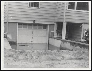 Sand by the in attempt to stem flow of water into this house on Lucy St.