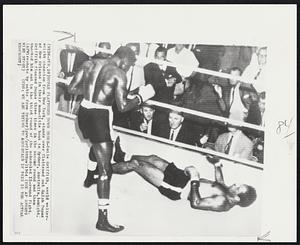 Dupas Flattened Down Under-Emile Griffith, world welterweight champion from New York, stands over flattened out Ralph Dupas of New Orleans in their non-title bout in Sydney, Australia, tonight. Griffith floored Dupas three times in the second round and then knocked him out in the third round of the scheduled 12-round fight.