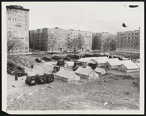 Mobile Field Hospital For Great Britain. New York City- The Mobile Field Hospital unit to be presented tomorrow to Great Britain by the American Field Hospital Corps, in elaborate ceremonies. The unit said to be the largest and most complete hospital for civilian relief ever constructed. It consists of 41 separate units and when fully erected, covers an area of two acres. With full supplies its cost is about $100,000. It is composed of 25 specially designed trucks and trailers, 16 water-proof tents, and is equipped to accommodate 100 bed patients and a hospital staff of 50 including doctors, nurses, orderlies and technicians.