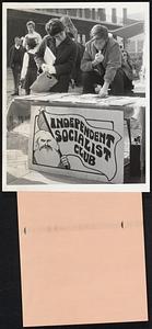 Student At His Stand Across American campuses, students are seeking more active participation in the educational structure while, at the same time, they try to improve a system they disagree with. Their committment, from the far left to the far right. takes the form of demonstrations, protests, group organizations such as Young Americans for Freedom on the right or Students for a Democratic Society on the left, speeches or other methods to say what they want. At Berkley's University of California, one student studies the offerings of the Independent Socialist Club while a member, sitting, explains such views.