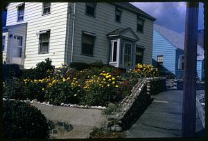 A house with flowers in front yard
