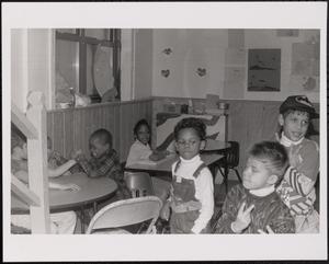 Group of children playing together at tables
