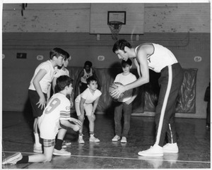 Bentley basketball player coaching children