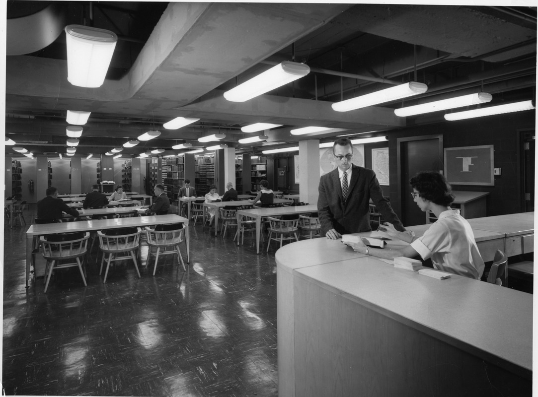 Librarians and students in old library building