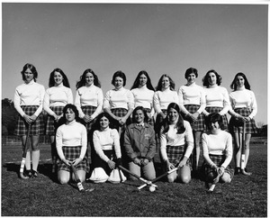 Women's field hockey team in uniform on field