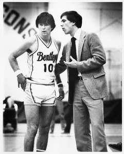 Bentley Falcons basketball coach Brian Hammel consults with player during a game
