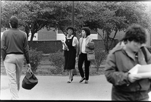 Two students walk together on campus fall 1984