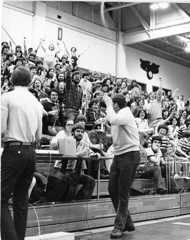 Members of band/orchestra at practice in gymnasium